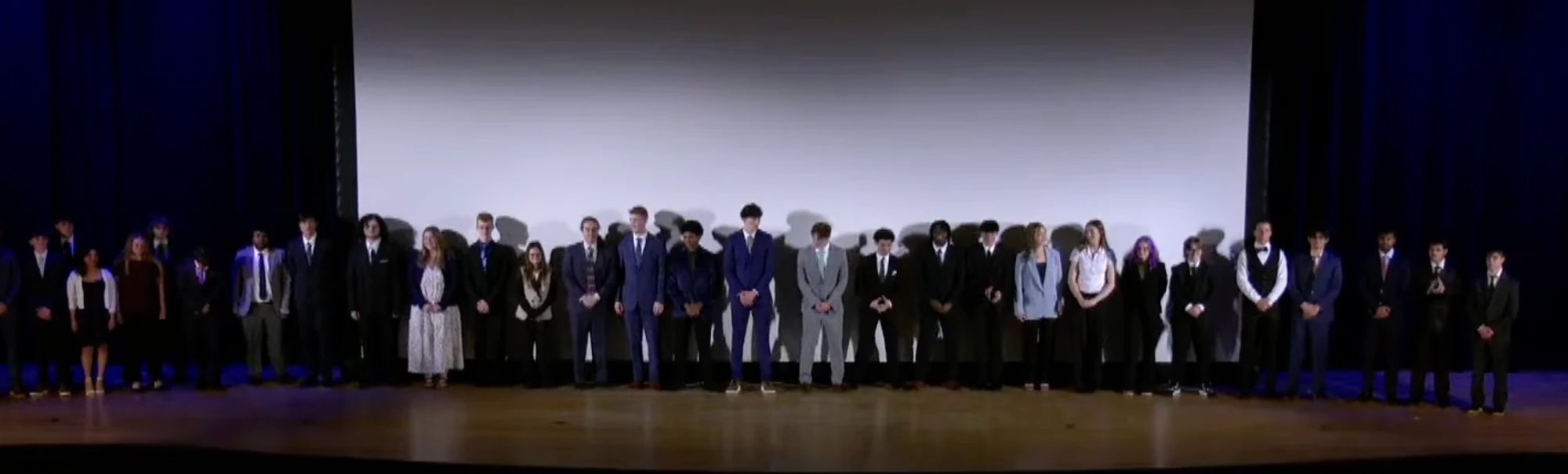 Engineering Design and Development seniors lined up on the auditorium stage after presenting their research to the North Penn community