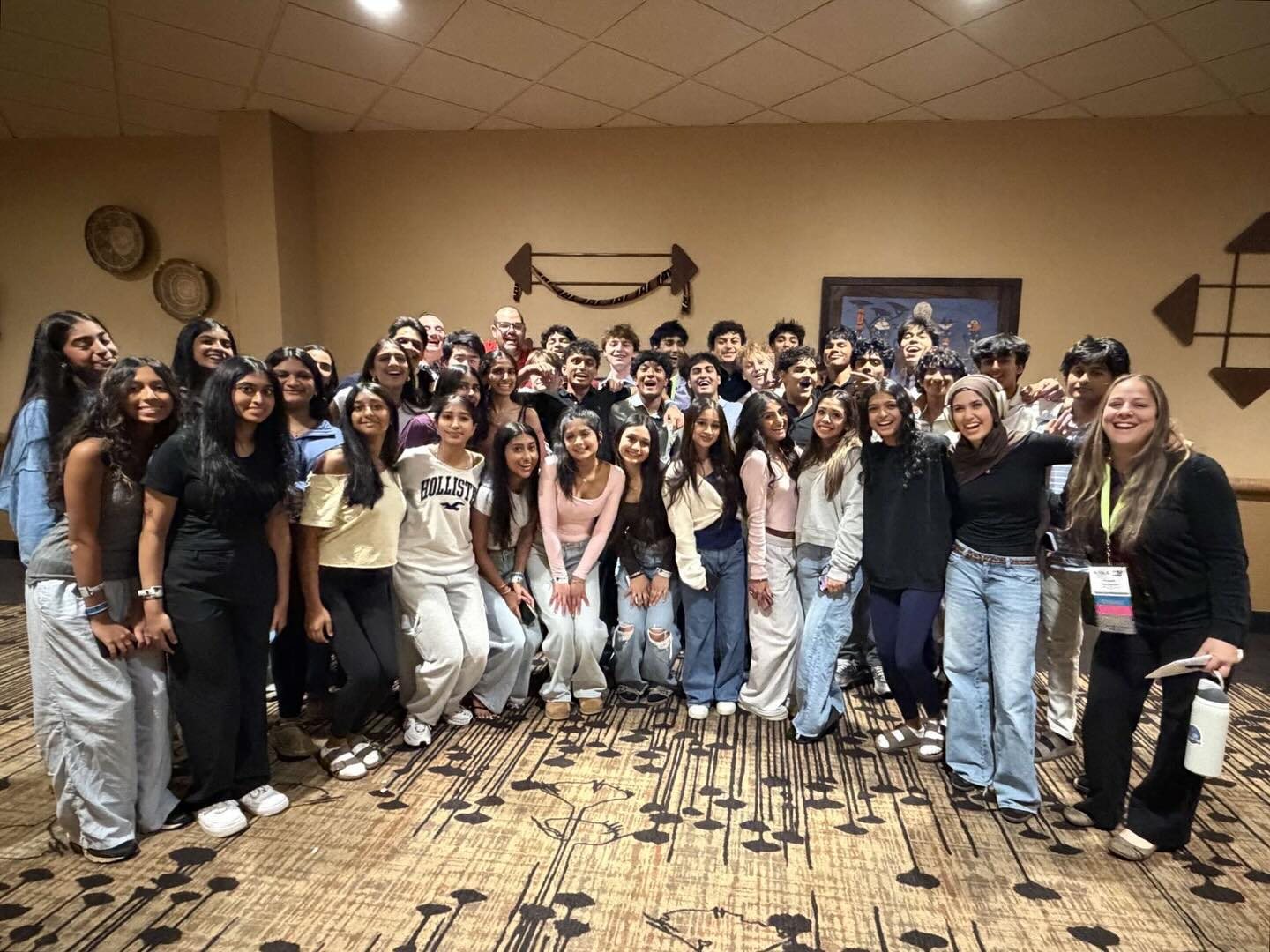 About forty-five smiling FBLA members packed together in a warm-lit hotel room