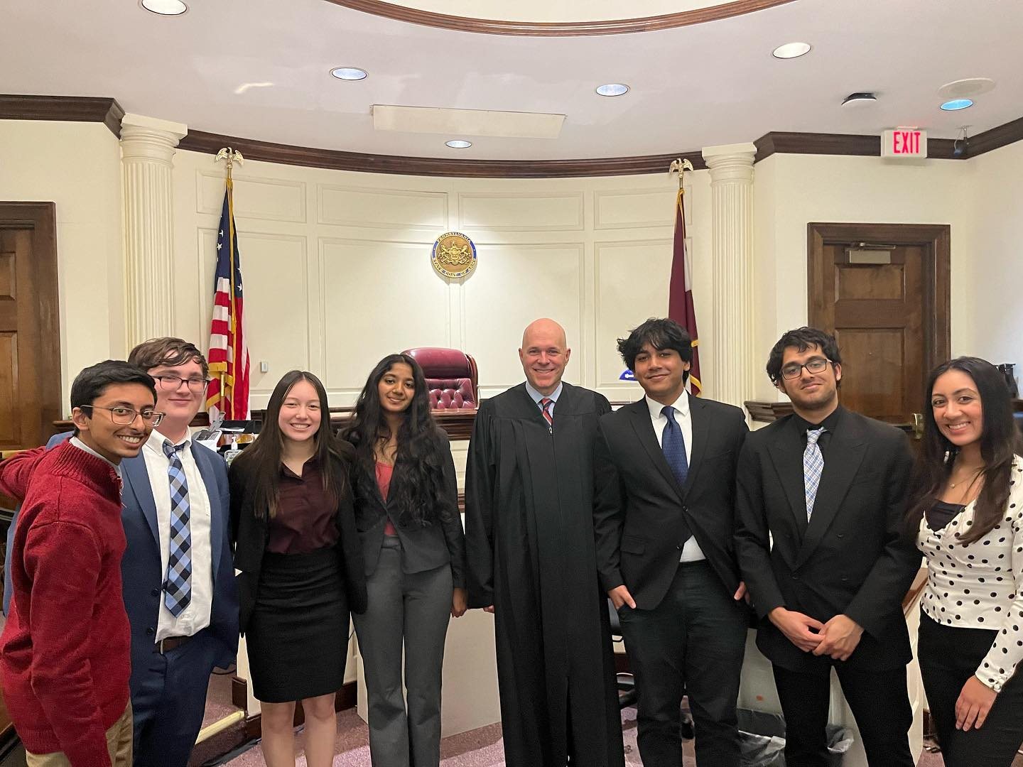 The Mock Trial team with a judge in a courtroom