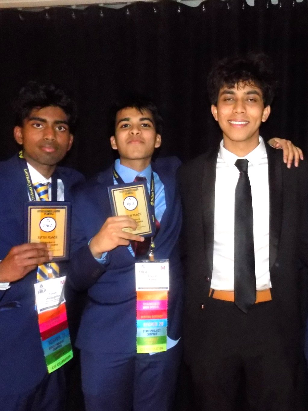 Members holding plaques at the awards ceremony