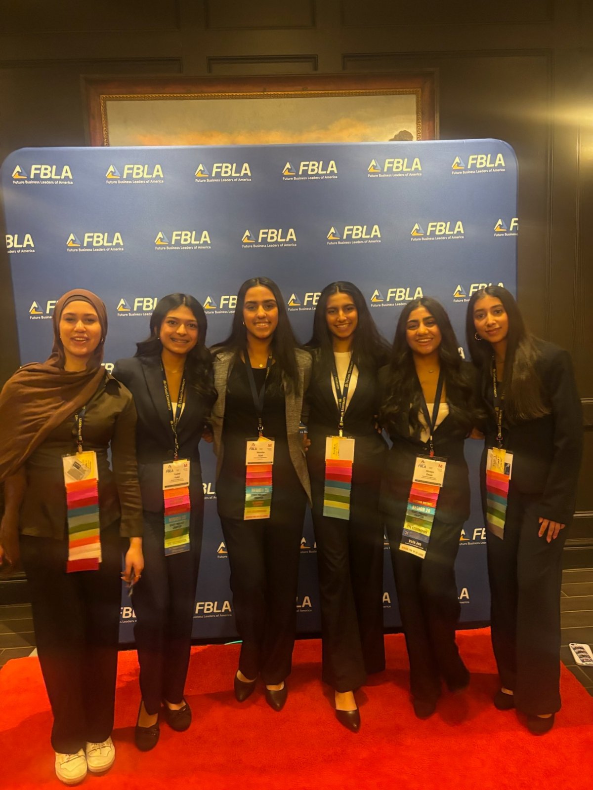 Members with award ribbons on the red carpet