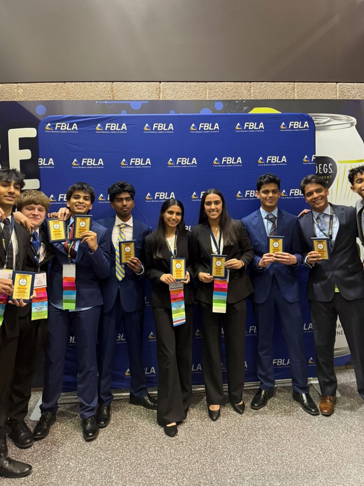 The chapter holding plaques in front of the FBLA banner